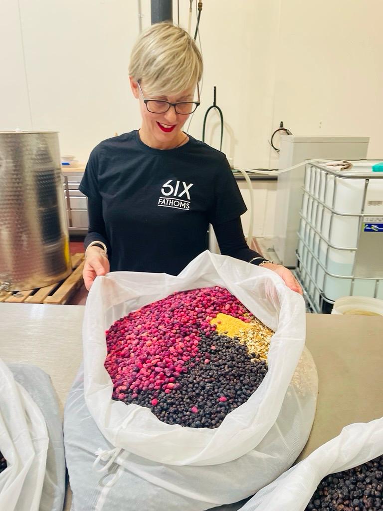 Lisa Chesterfield with a bag of riberries and botanicals